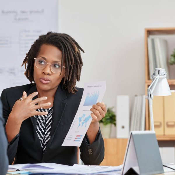 portrait-attractive-cuban-woman-presenting-statistical-information-her-unrecognizable-boss (1)